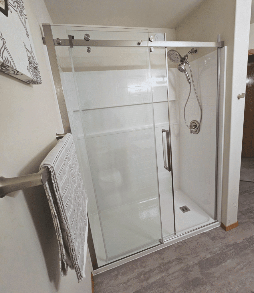 Modern glass shower with towel rack in St. Andrews, MB